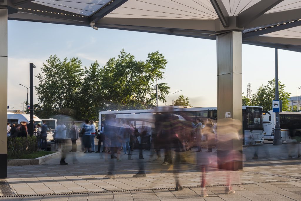 passengers waiting and boarding buses at the bus terminal